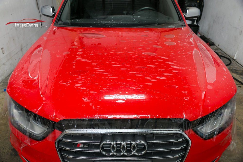 Red car hood covered with protection film