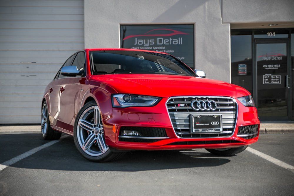 Red Audi S4 parked in front of Jays Detail business with bright sunlight.