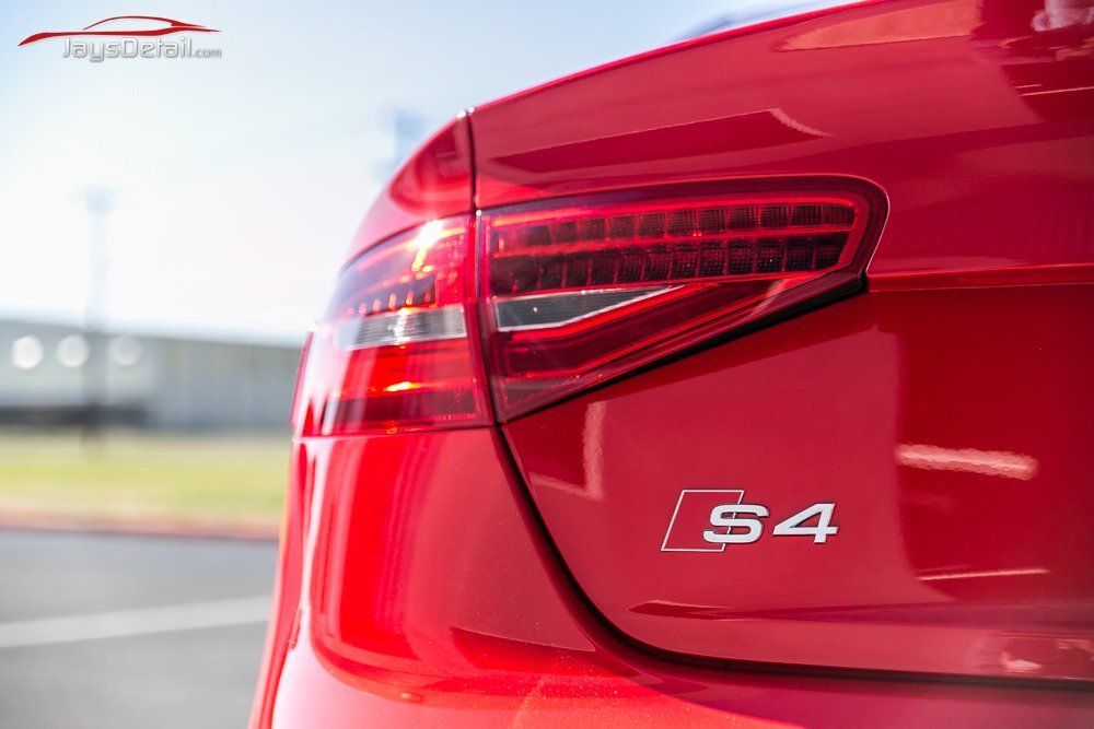 Red Audi S4 rear with taillight and badge.