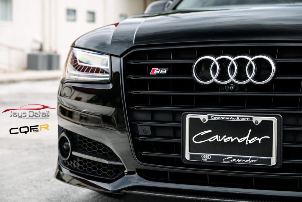 Black Audi car front with grill, license plate