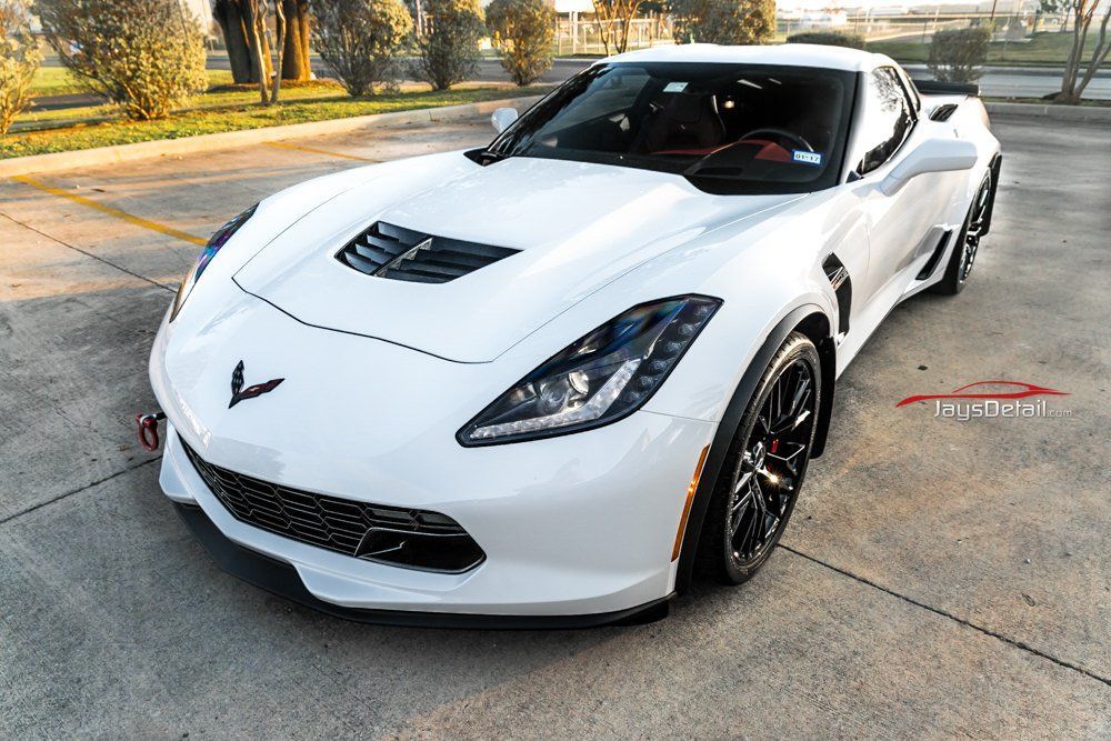 White Chevrolet Corvette sports car parked outdoors.