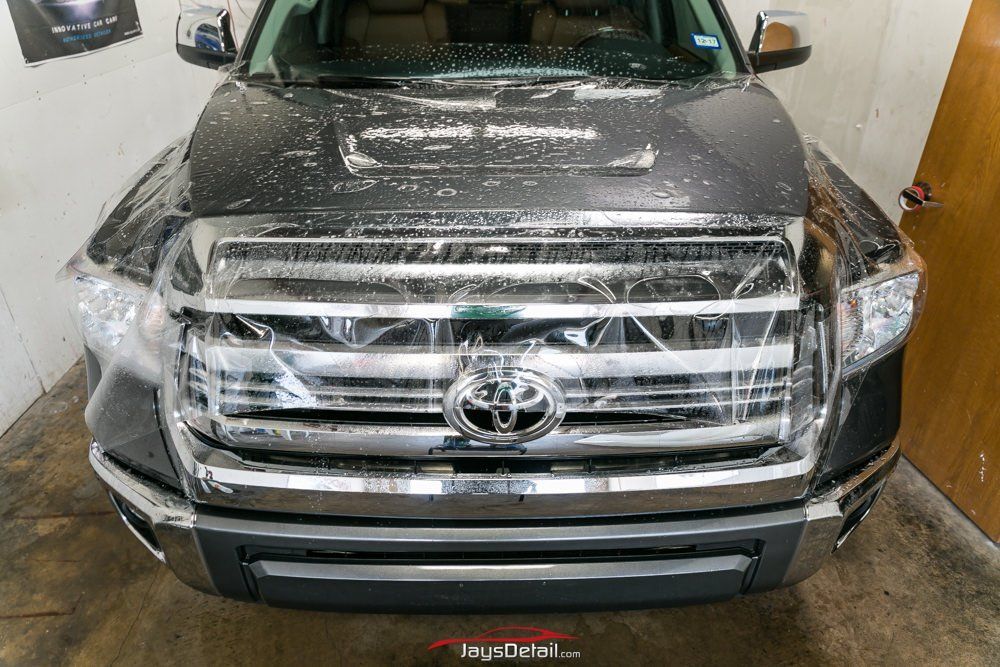 A Toyota Tundra truck with protective film applied to its front end.