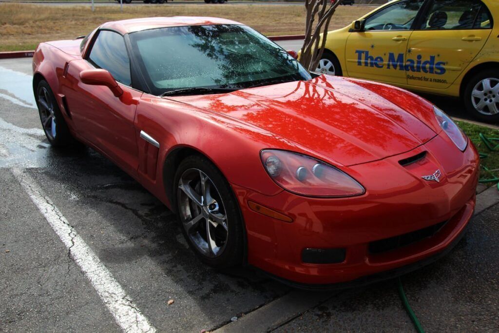 Red Corvette parked on asphalt