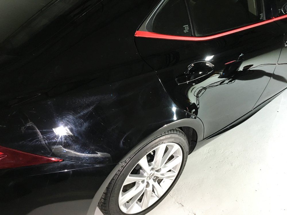 Black car with a red trim detail and shiny paint.