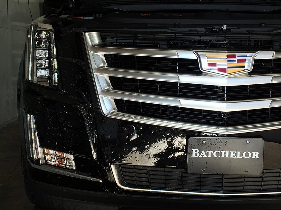 Black Cadillac Escalade front view with chrome grille and