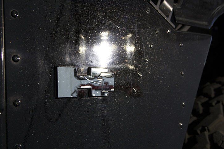 Gray metal door with a damaged metal lock.