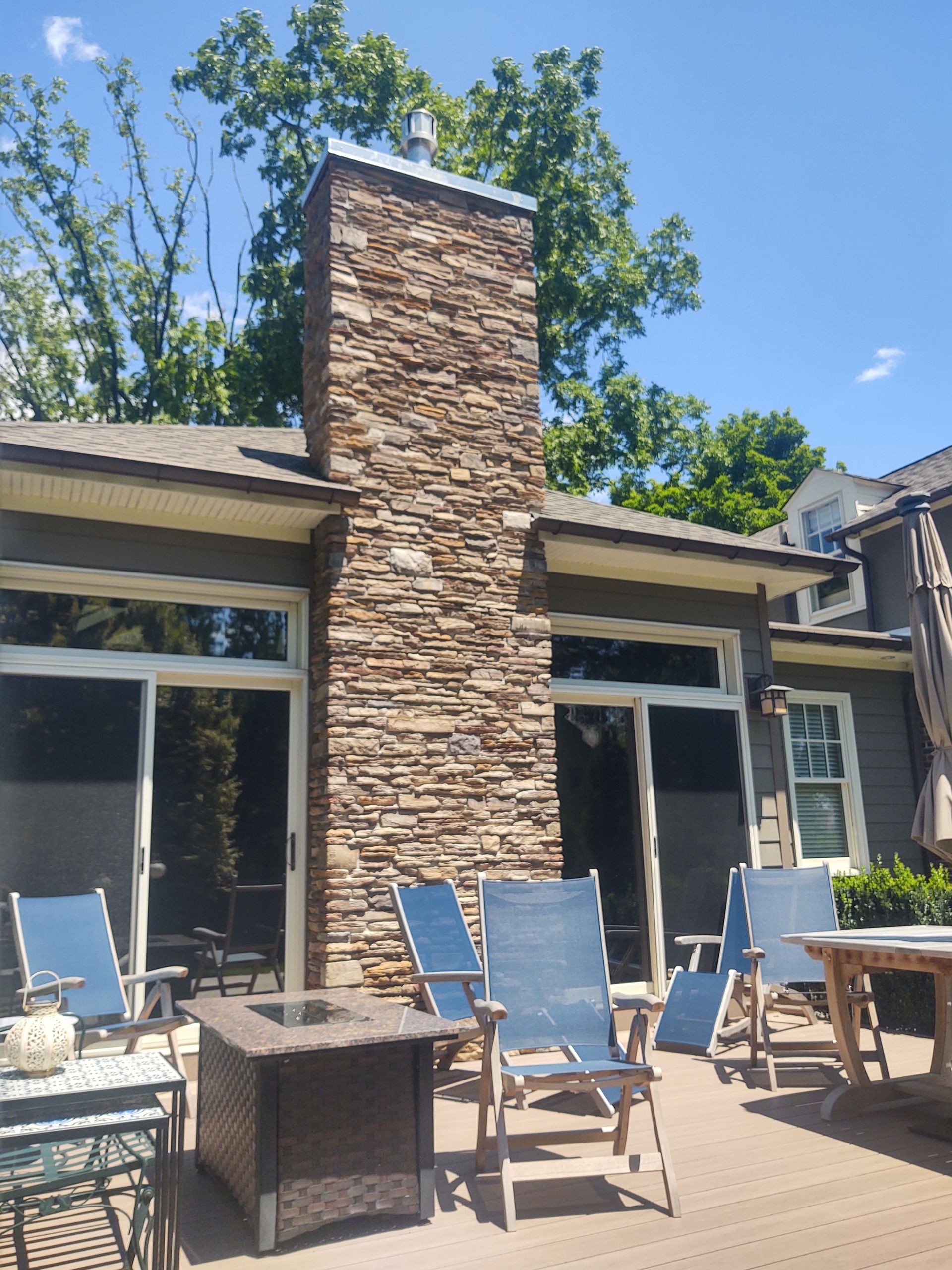 A Patio with Chairs and A Fire Pit in Front of A House