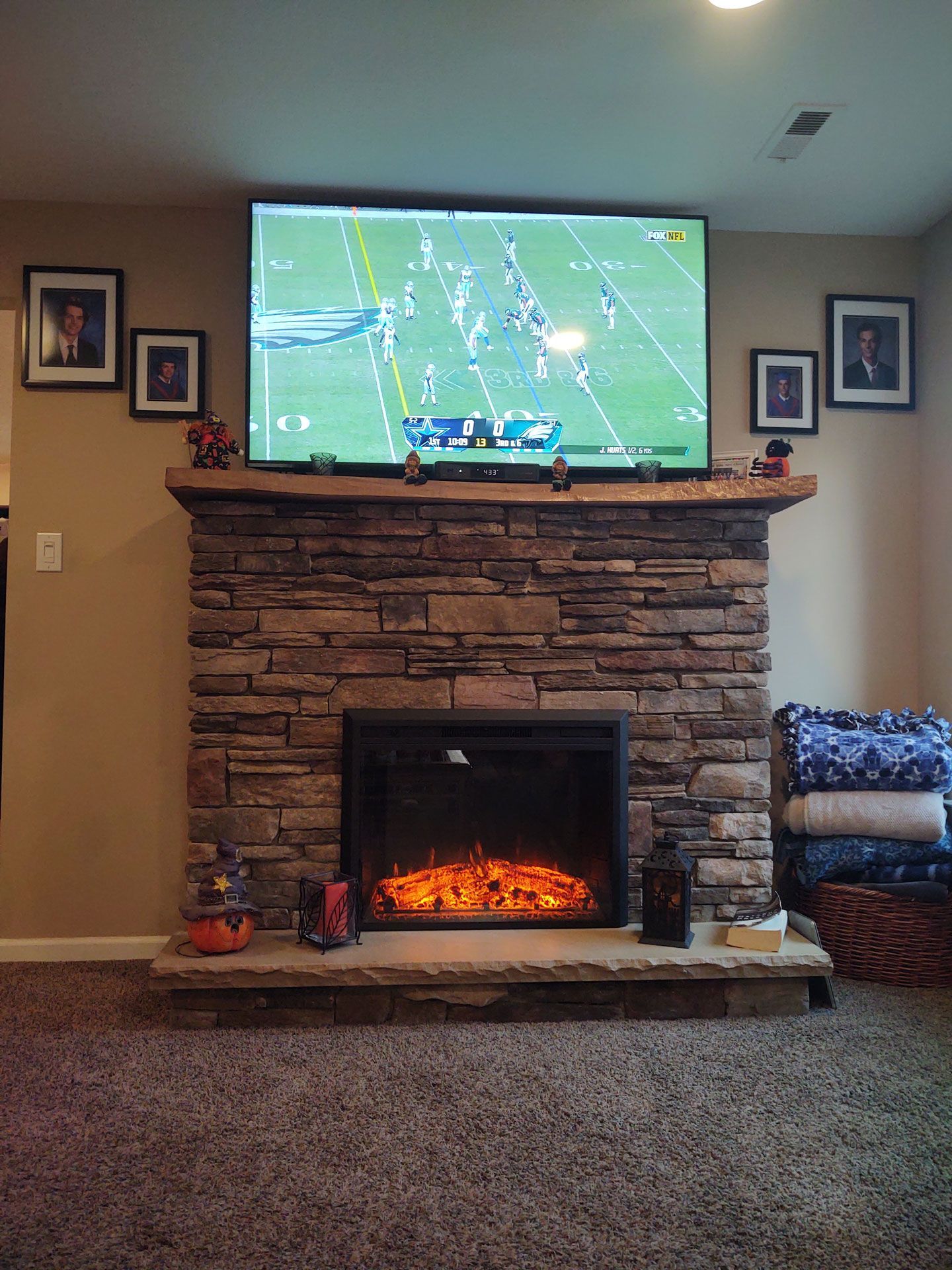 A living room with a fireplace and a big flat screen tv.