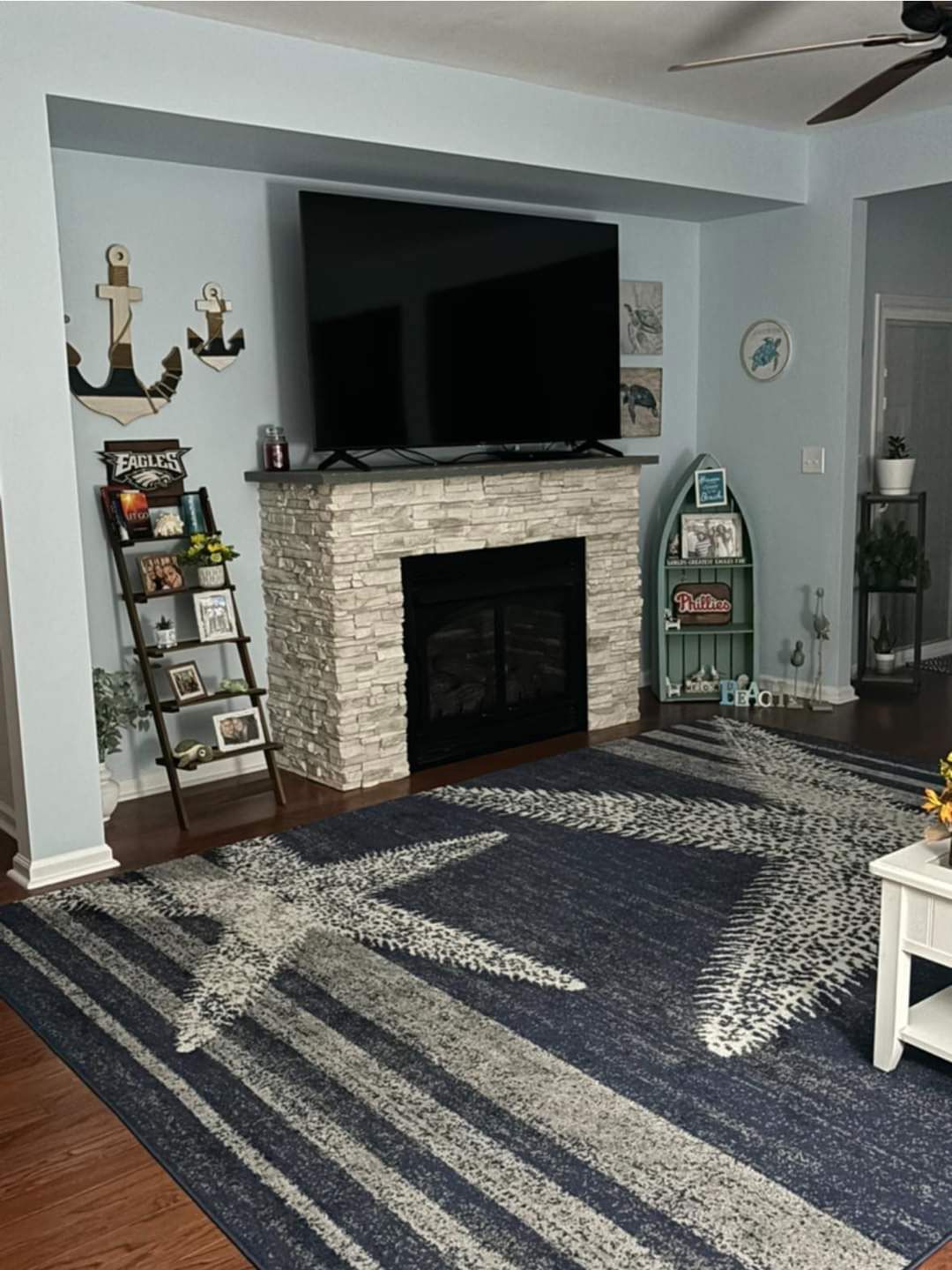 A white living room with a fireplace and a flat screen tv.