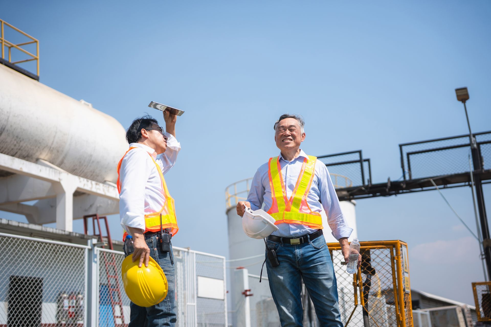 Heating oil supplier representatives inspecting fuel facility operations and storage systems.