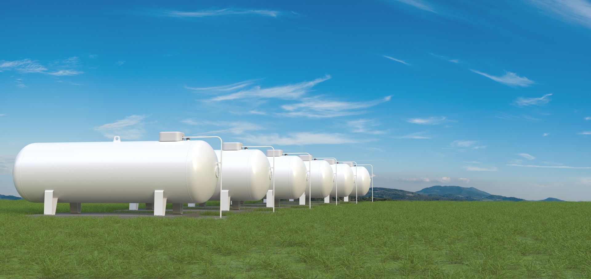 Row of big gas tanks in summer landscape. Row of big gas tanks in summer landscape.