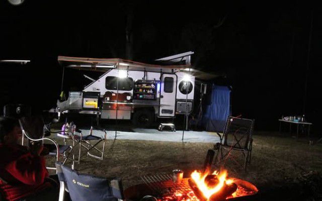 Experience The Allure of Our Camper Trailer Amidst a Crackling Campfire, Embodying The Essence of Outdoor Adventure — Ozzie Camper Trailers in Aitkenvale, QLD