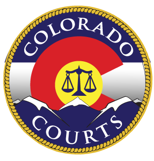 Colorado courts seal with red, yellow, blue, and a scales-of-justice emblem