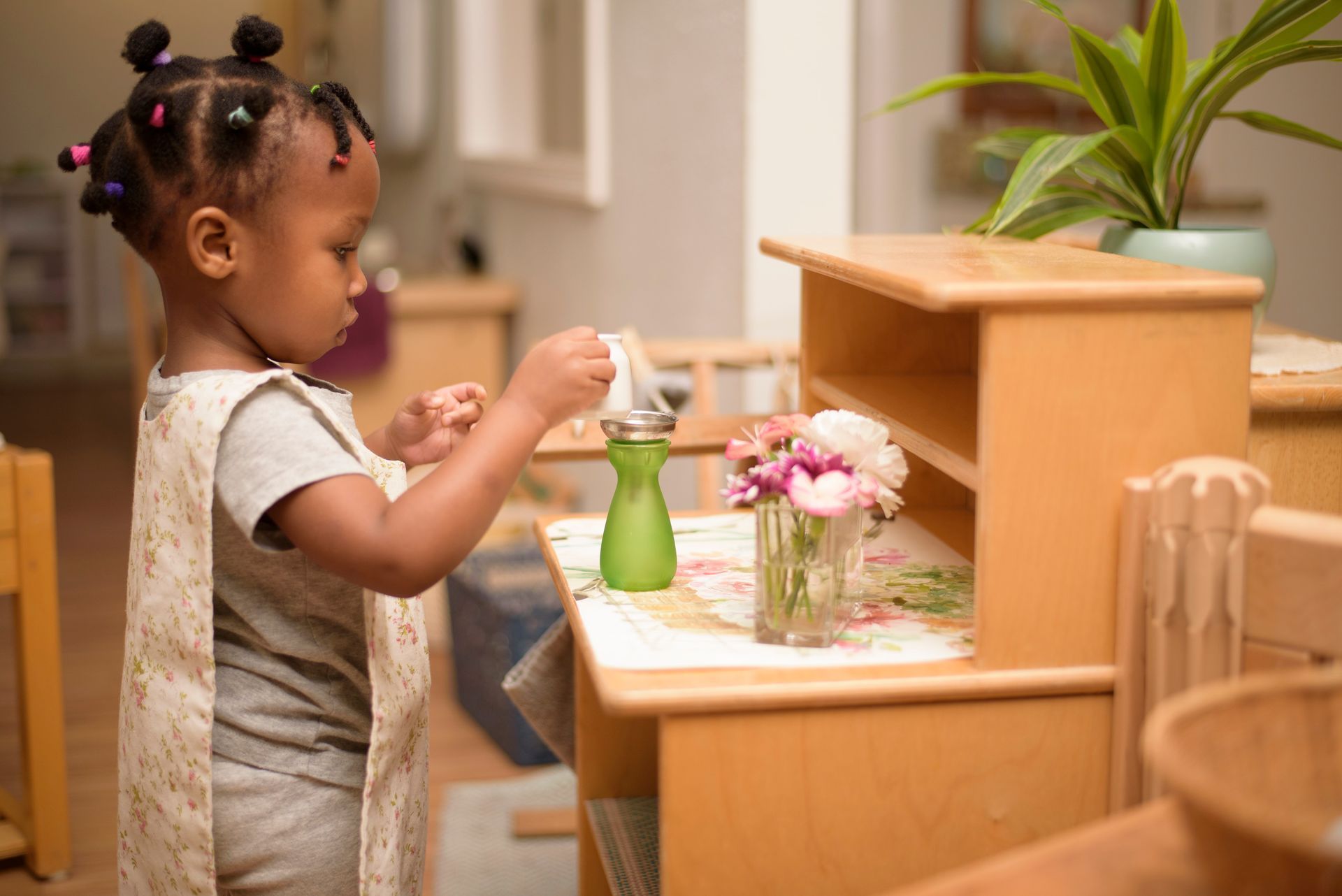 Montessori child working with practical life materials