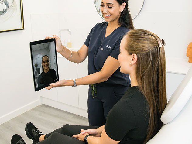 Patient looking at results after getting lip fille treatment