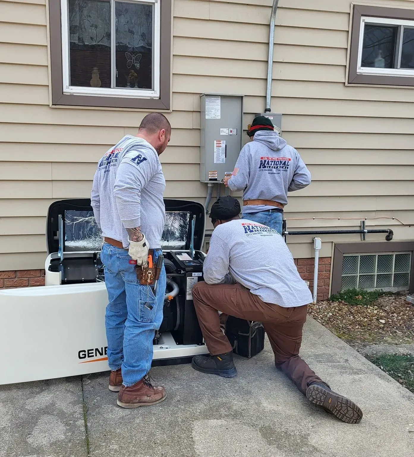 Three men are working on a generator outside of a house.