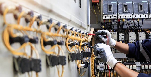 Air conditioning units with toolbox and gloves in backyard.