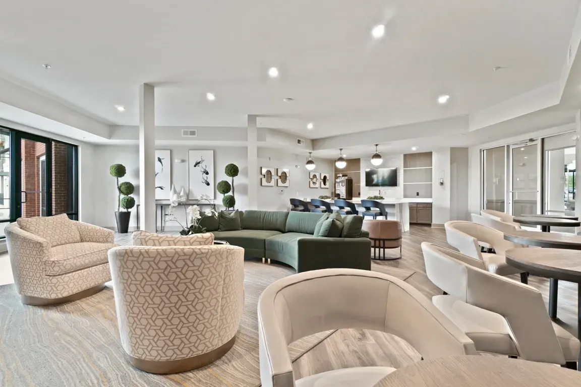 Modern lounge area with plush seating, a sectional sofa, and a bar.