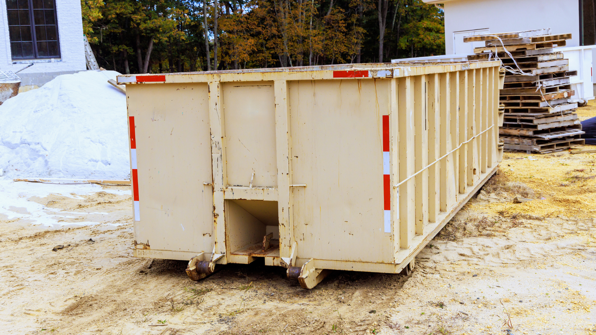 Heavy debris dumpster placed near construction site foundation work
