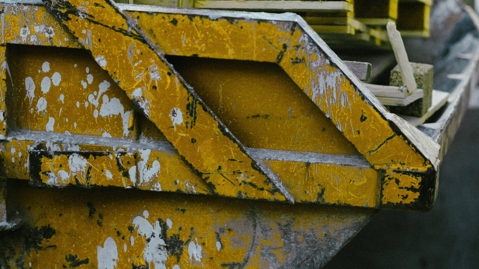 Construction materials sorted into waste container at worksite
