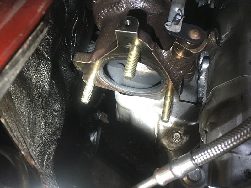 A Close Up of a Car Engine With a Hose Attached to It — Hastings River Brake & Exhaust in Port Macquarie, NSW
