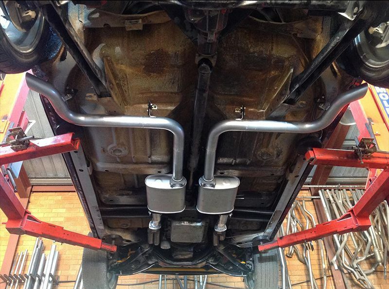 A Car is Sitting on a Lift in a Garage — Hastings River Brake & Exhaust in Port Macquarie, NSW