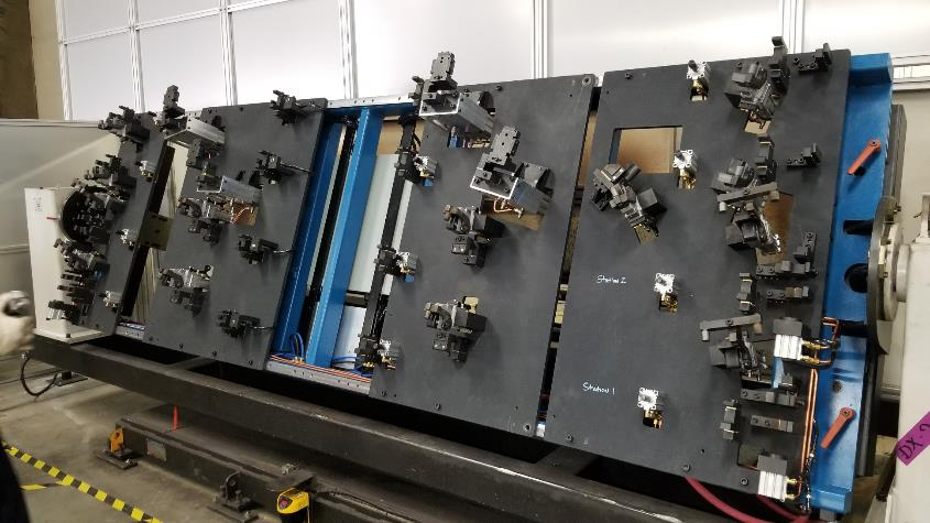Large industrial fixture with multiple panels, various clamps, and adjustments, possibly for manufacturing.