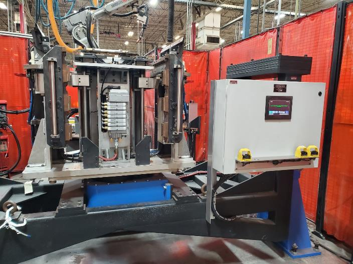 Industrial robotic welding machine in a factory setting.