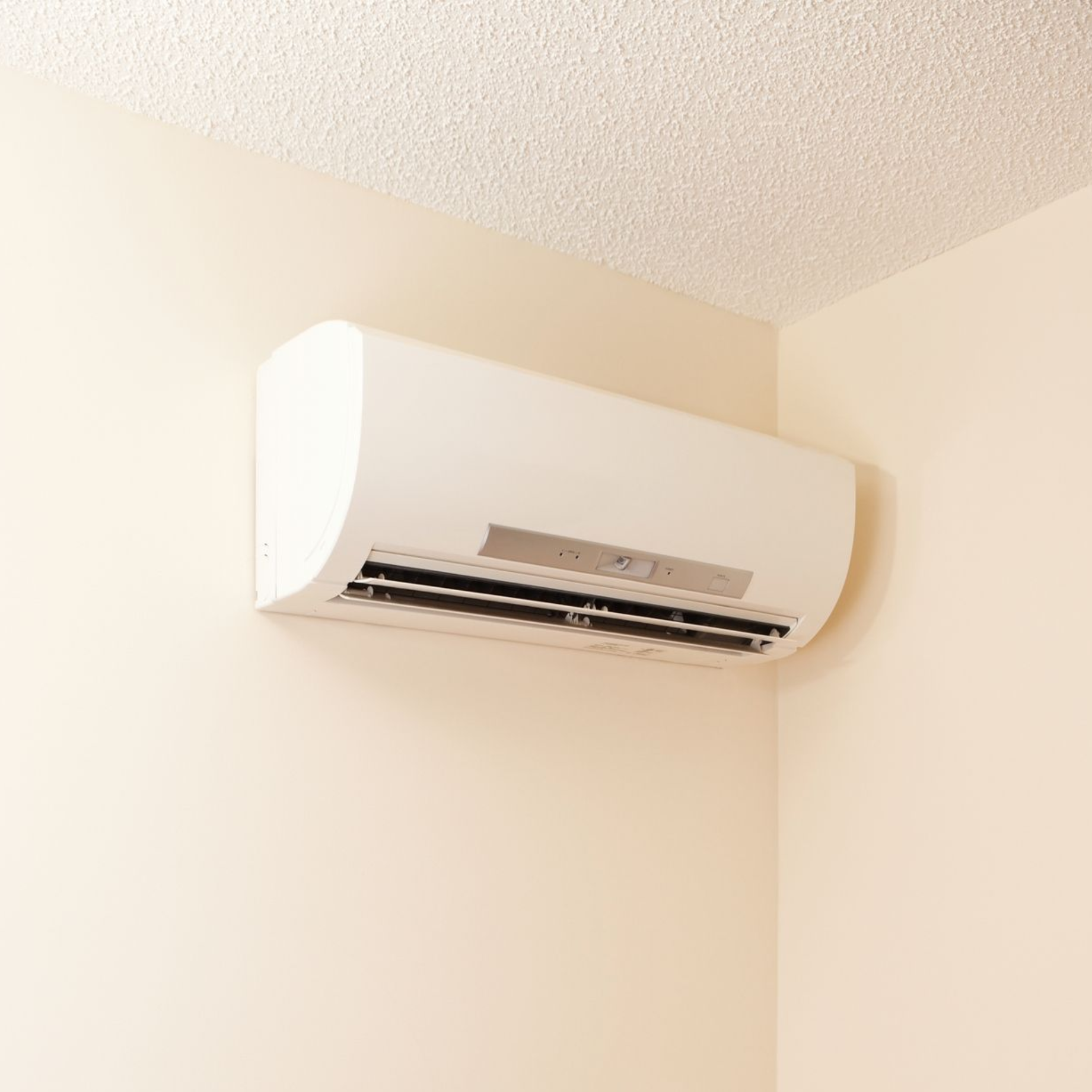 Wall-mounted ductless mini split heating and cooling unit installed inside a home.