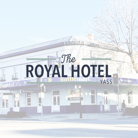The Royal Hotel in Yass with white and blue exterior, and a Bottlemart sign.