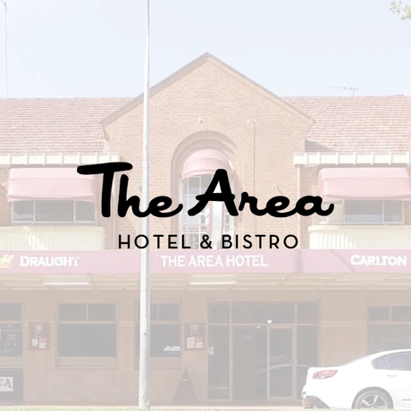 The Area Hotel & Bistro, a brick building with a logo overlaid, features a white car in the foreground.
