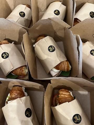 Boxes of pastries with paper sleeves, arranged in a neat grid.