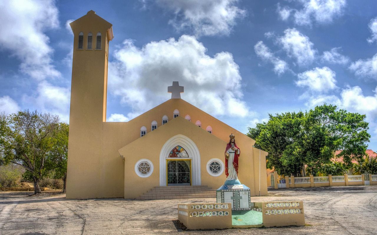 A church with a statue of jesus in front of it.