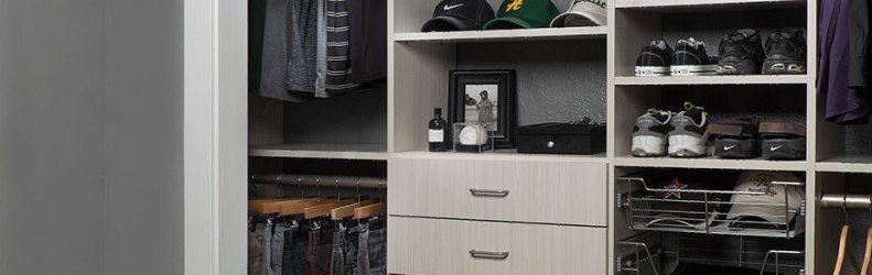 A customized closet with shelves and drawers holding clothes, shoes, and accessories.