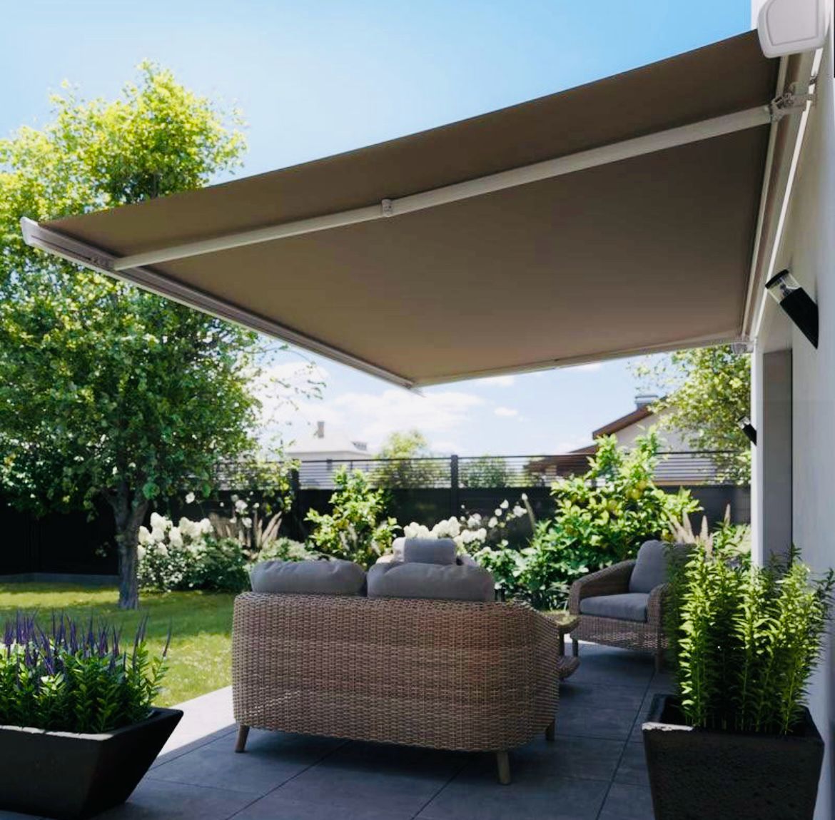 un patio con divano e sedie sotto una tenda da sole