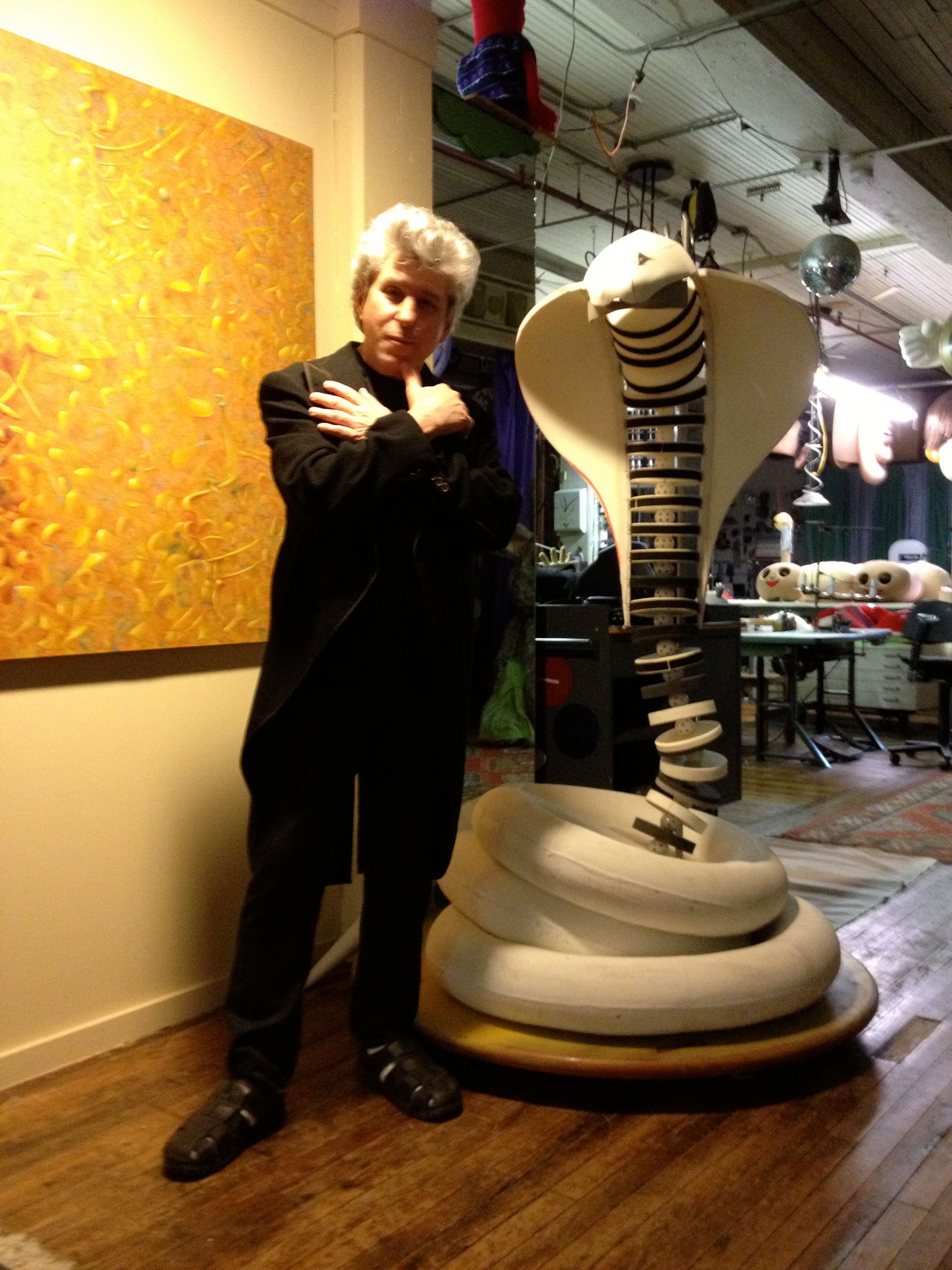 A man standing next to a statue of a cobra
