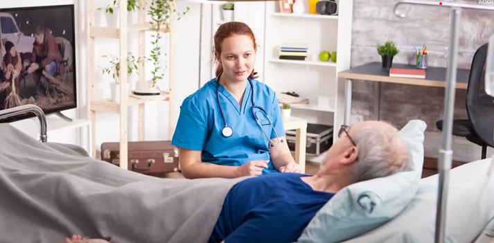 Nurse at bed side of patient offering palliative care