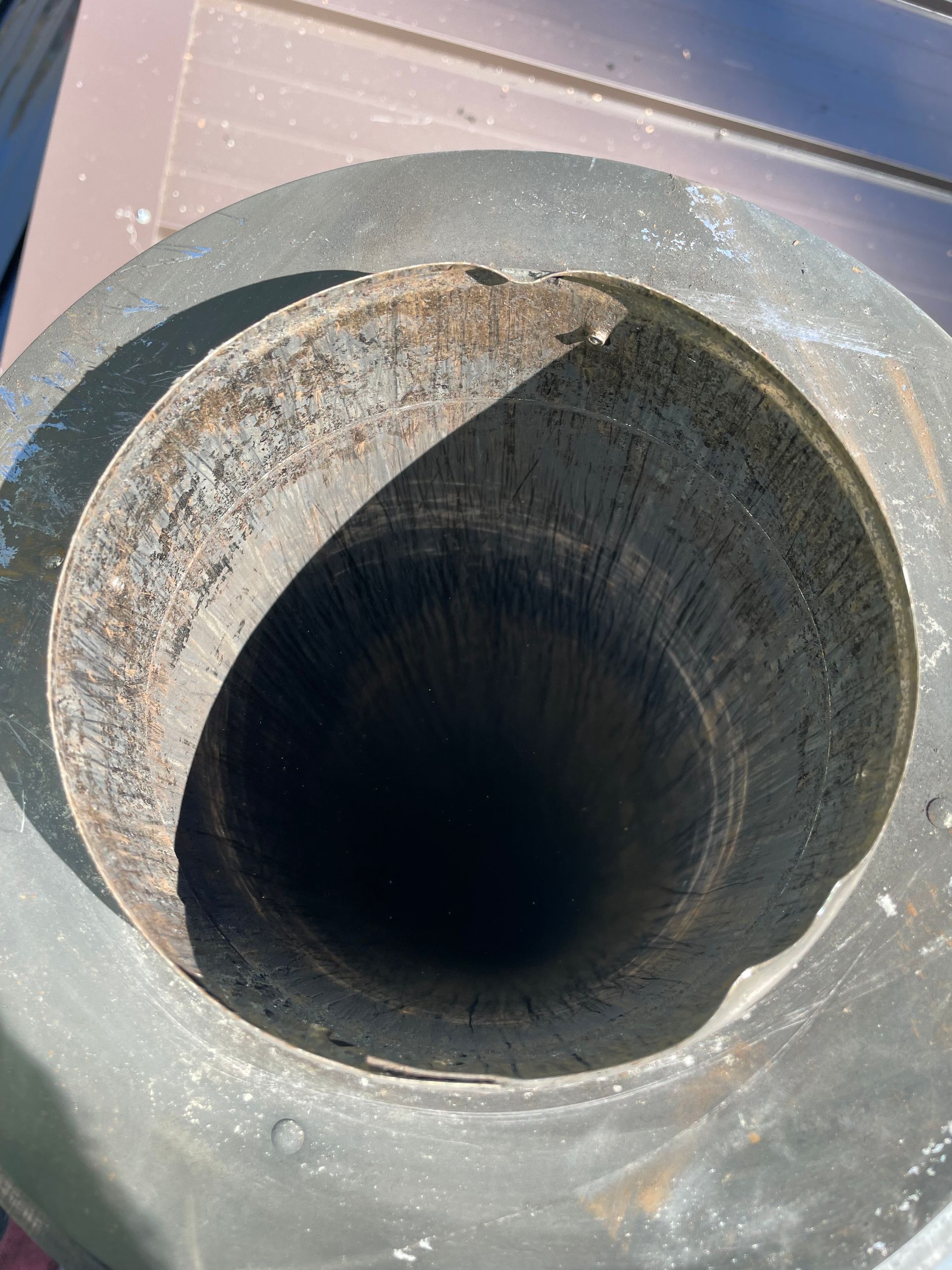 Looking down a rusty, circular pipe.