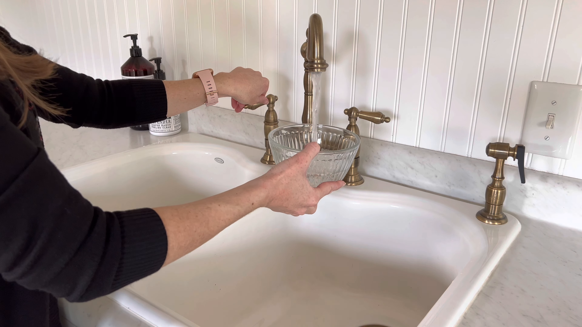 Cleaner wiping down a kitchen surface in a Queens apartment