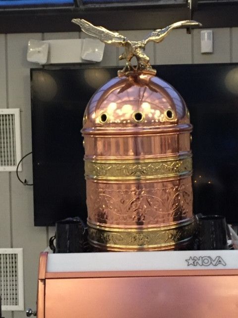 a large copper object with an eagle on top of it