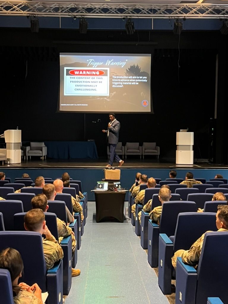 A man is giving a presentation to a group of soldiers