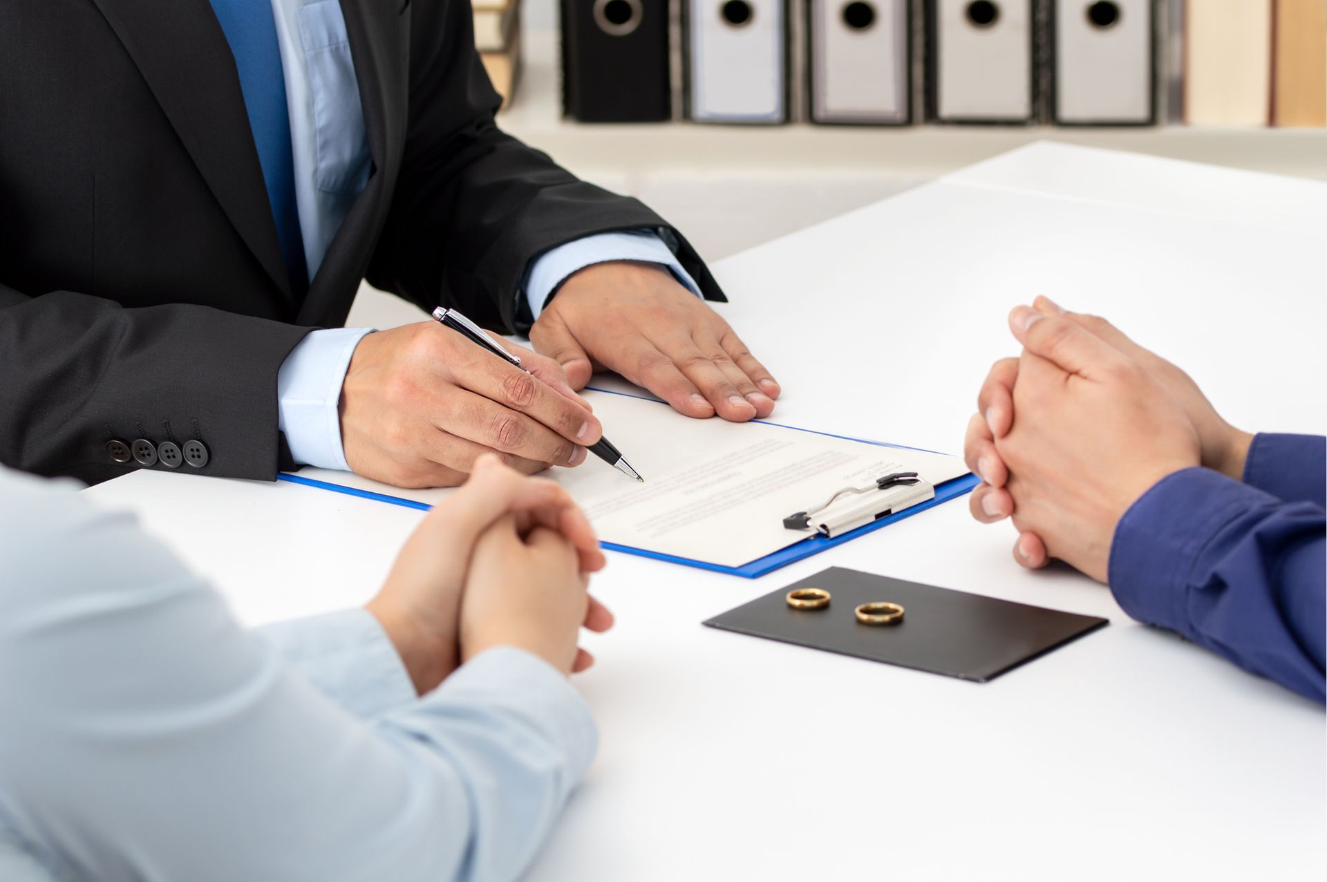 A couple meeting with a divorce lawyer to resolve asset and property division.