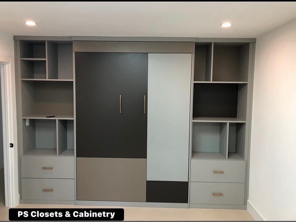 Built-in closet wall with dark and light sliding doors, shelves, drawers, and recessed ceiling lights
