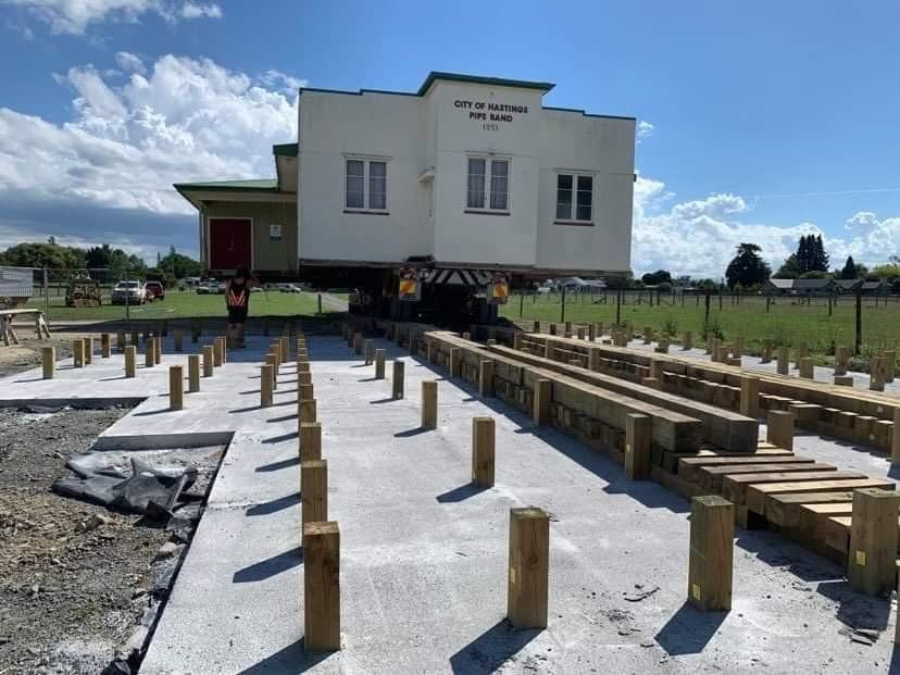 House under construction with wooden framing and concrete foundation on a cloudy day