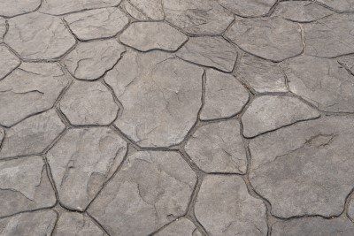Cracked gray stone pavement with irregular polygon patterns