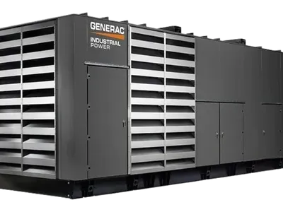 Large Generac industrial power generator, gray with louvered sides.