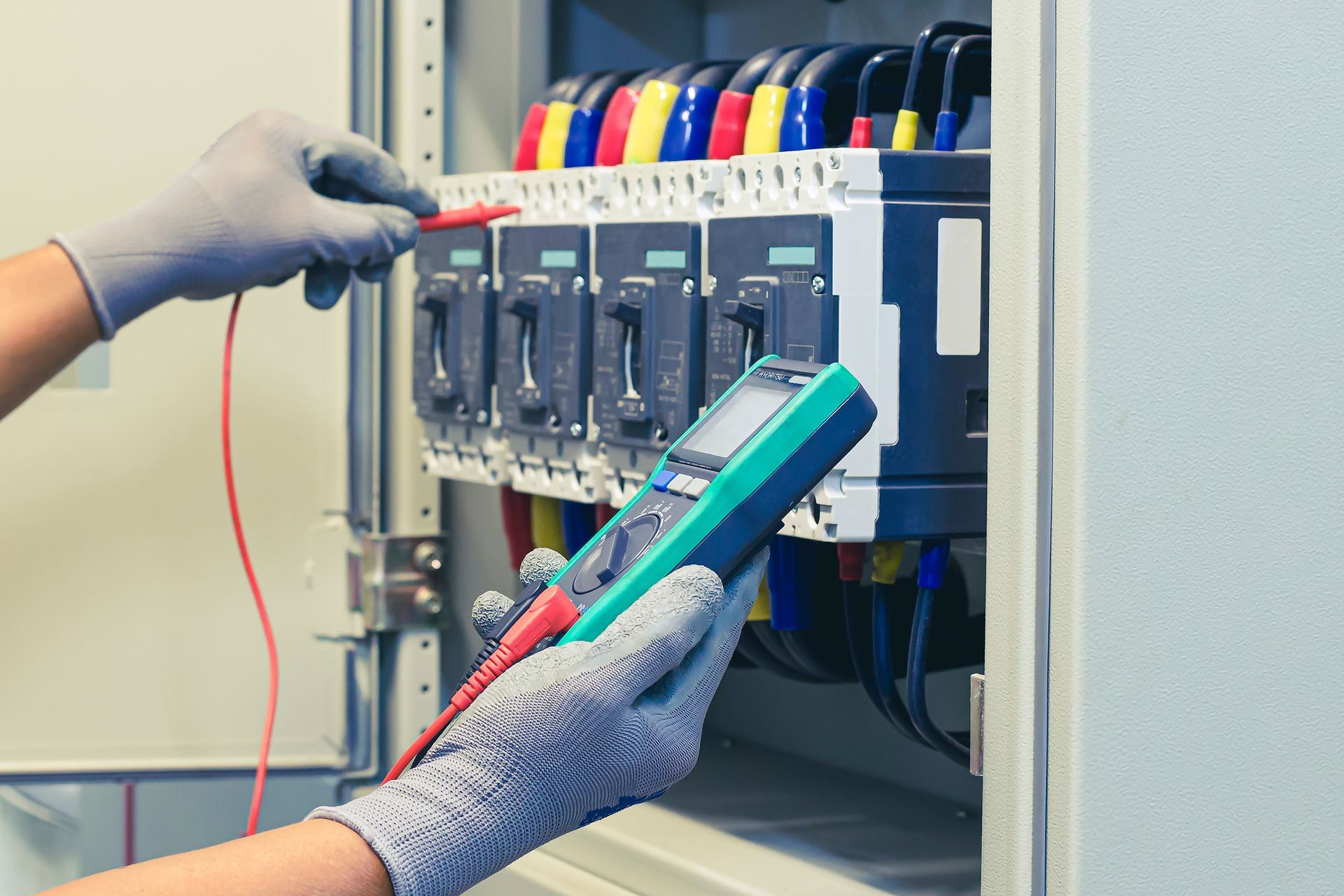 Dense panel of electrical relays, wiring, and control components on a blue industrial board