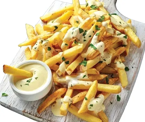 A cutting board topped with french fries and a bowl of sauce.