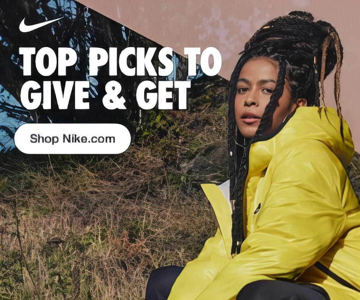 Nike banner a woman wearing a yellow nike jacket is sitting in a field 
