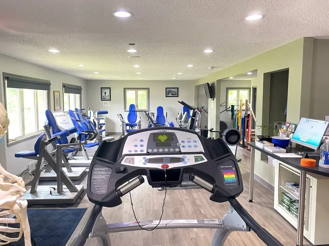 A treadmill is in the middle of a gym
